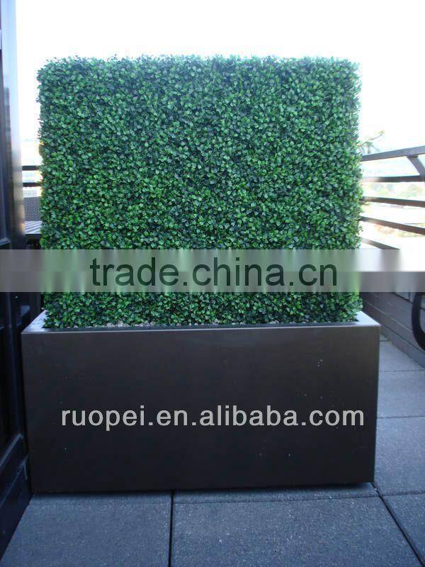 Vertical artificial plastic green wall and hanging decorations