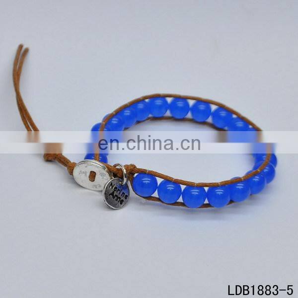 Handmade beaded wrap bracelet features 3 rows of circular and square stones surrounded by a natural colored cord on both sides