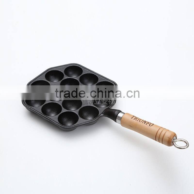 Mini cast iron takoyaki grill with wooden handle