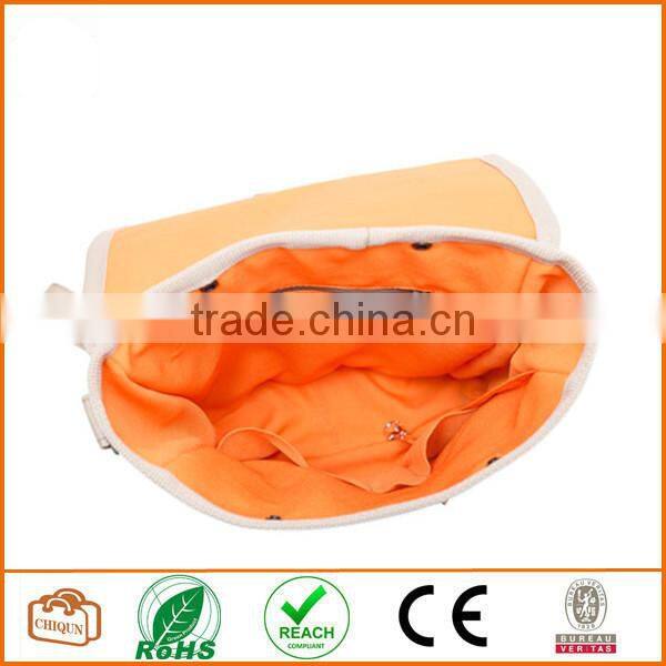 Unisex messenger bag and backpack. Brown Canvas with orange details and lining. Multiple pockets