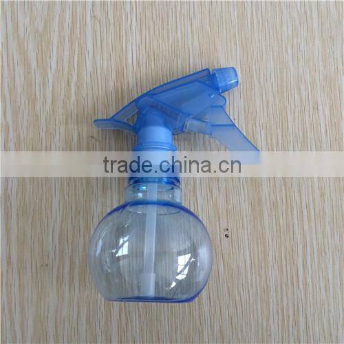 blue transparent plastic garden spray bottle with trigger
