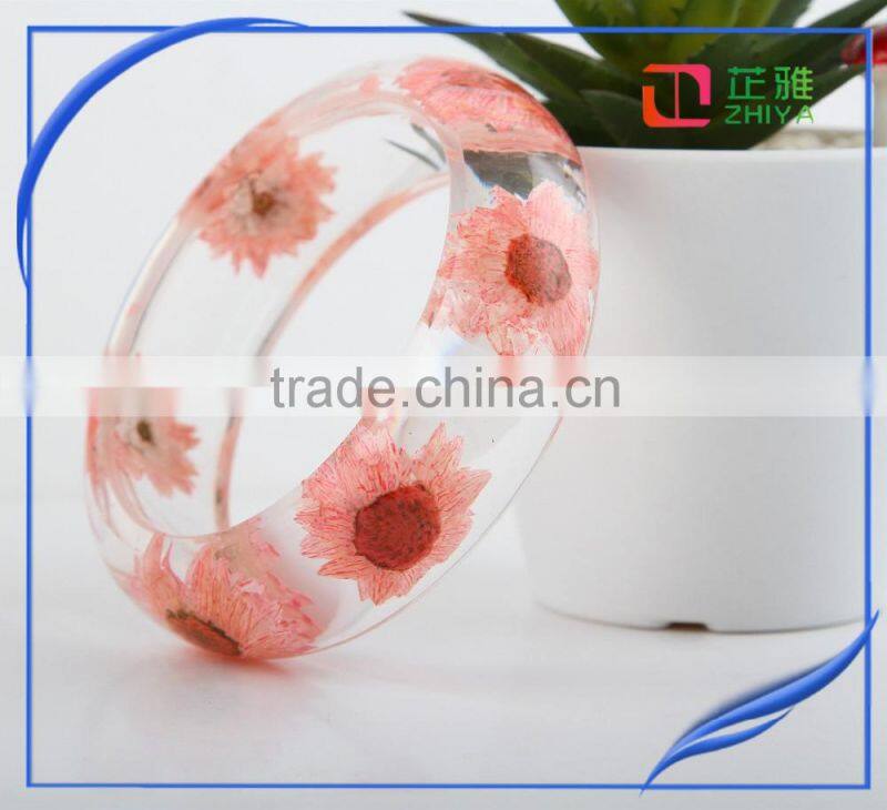 Pine needles inside transparent clear acrylic bangle stand