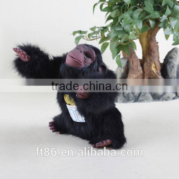 Furry toy looking up lifelike fake animal gorilla