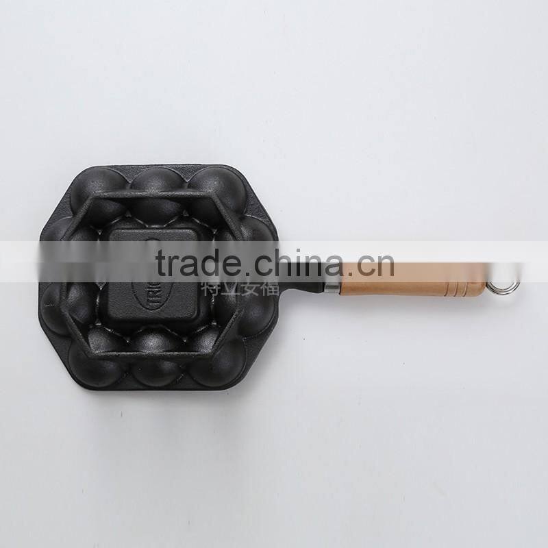 Mini cast iron takoyaki grill with wooden handle