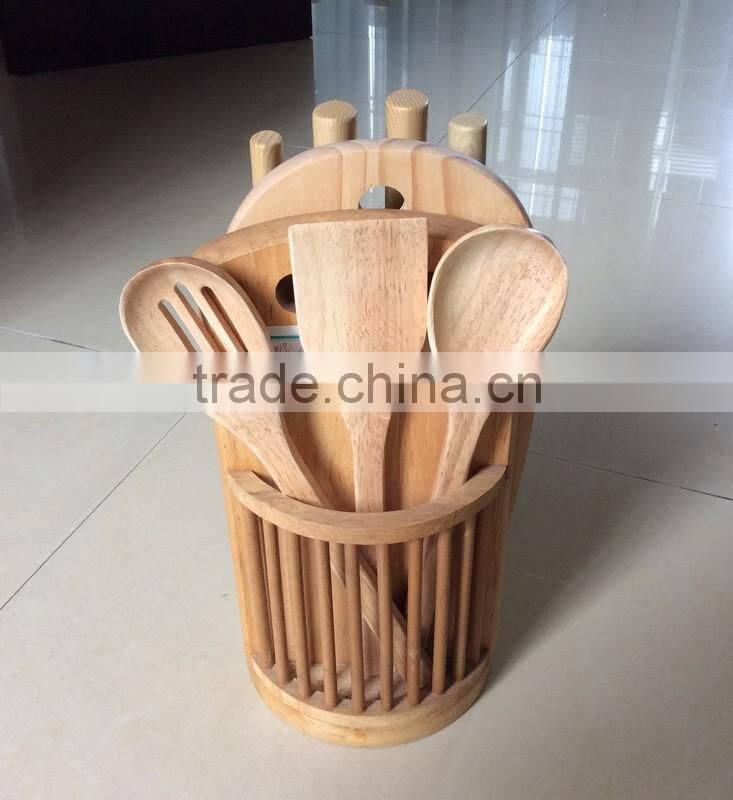 wooden knife block with three wooden utensils, four knives and 1chopping board