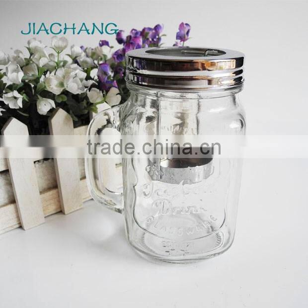 Decorated candle in clear glass jar