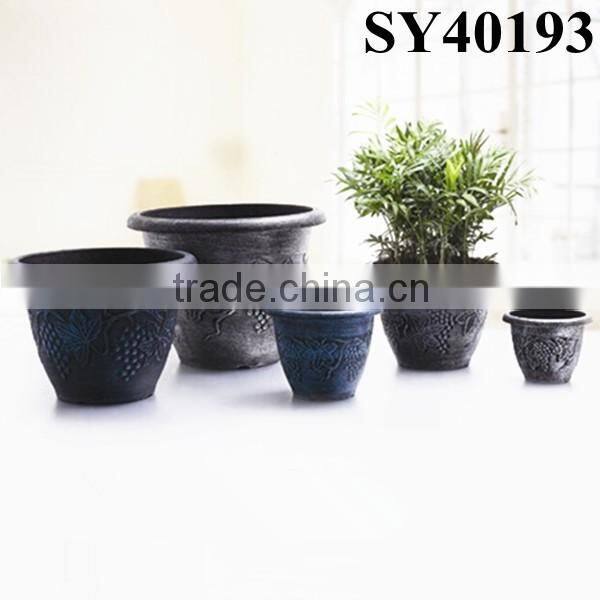 Painting round large coloured plastic flower pot