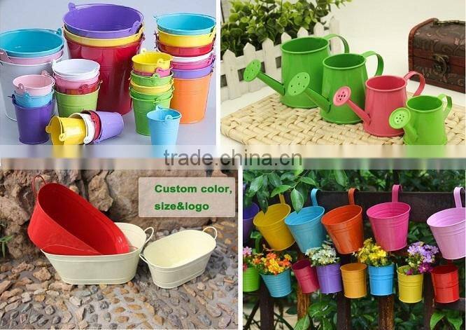 Round and oval shaped white metal planters for outdoor and garden decoration