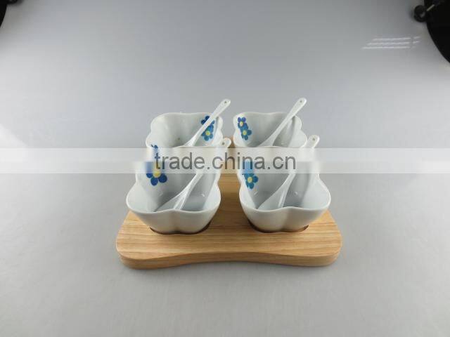 white porcelain clover-shaped dish set with spoon and wood tray