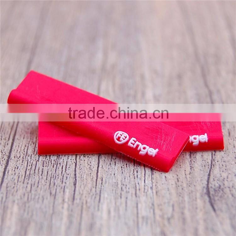 Private red embossed logo heat transfer silicone label for mens jeans