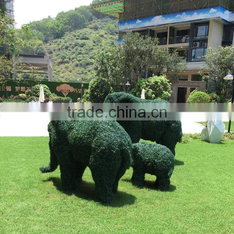 Green grass elephant statue