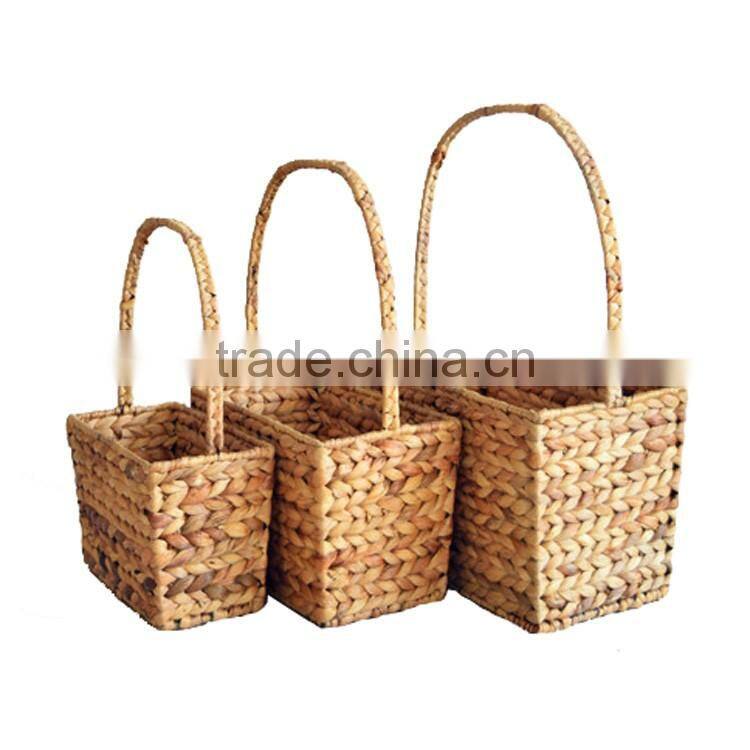 Set of 3 stackable hand woven natural straw baskets with handles
