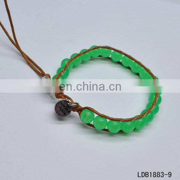 Handmade beaded wrap bracelet features 3 rows of circular and square stones surrounded by a natural colored cord on both sides