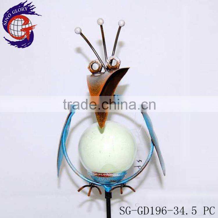 decorating garden edging with metal glow in dark bird stake