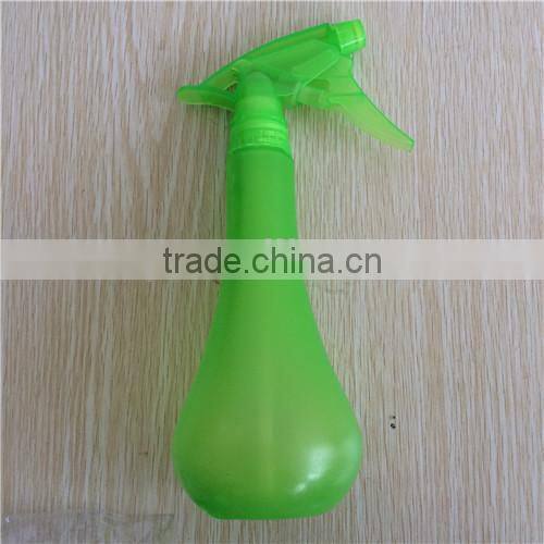 green plastic garden spray bottle with trigger