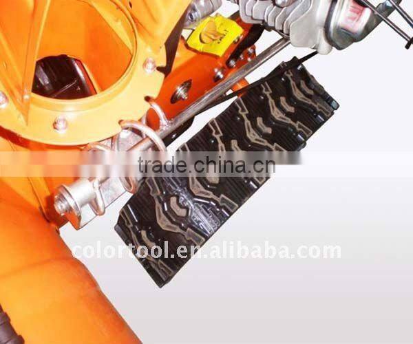 Two-stage track snow thrower