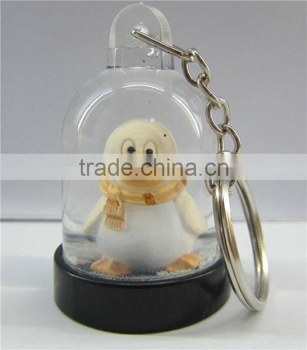 Plastic snow globe penguin key chain