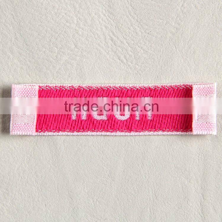 Garment woven label main label with white background and pink fonts