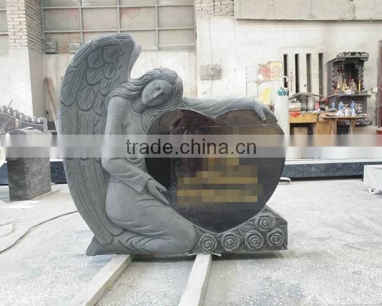 Hand carved angel holding granite heart tombstone