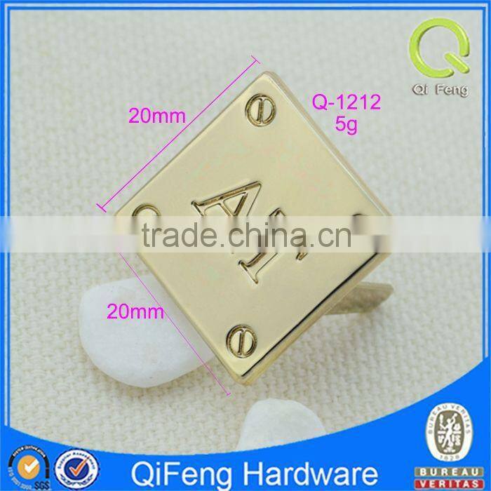 Q-1212 custom handbag label engraved with letters "AT"