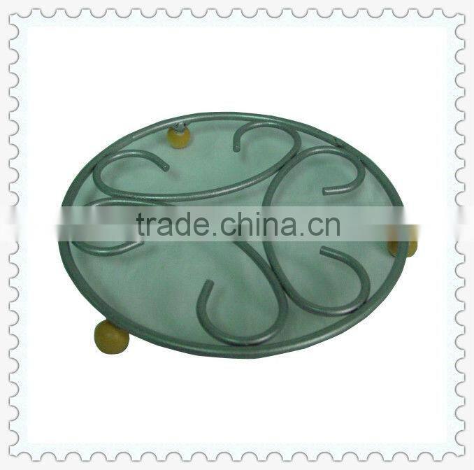 antique metal round shape cast iron trivet