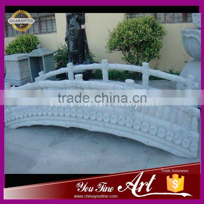 decorative garden bridge in stone