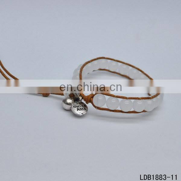 Handmade beaded wrap bracelet features 3 rows of circular and square stones surrounded by a natural colored cord on both sides