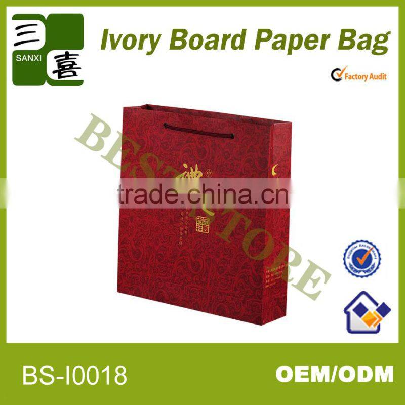 red printed paper gift carry bag with ribbon