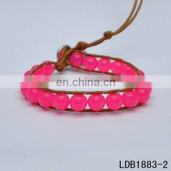 Handmade beaded wrap bracelet features 3 rows of circular and square stones surrounded by a natural colored cord on both sides