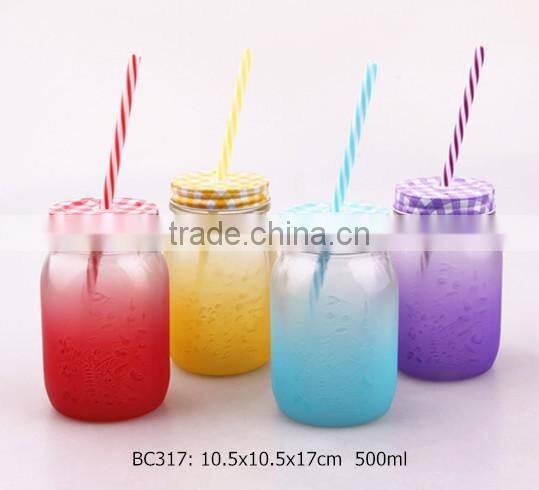 glass mason jar with sprayed color and colorful plastic straw
