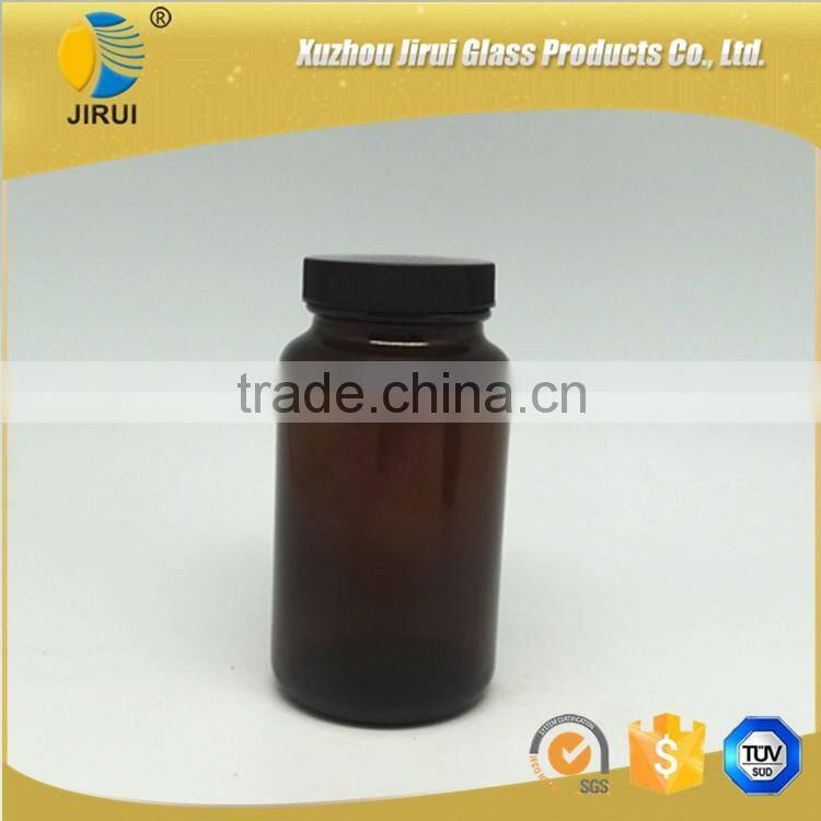 Amber vitamin pill glass bottle with lined black closure