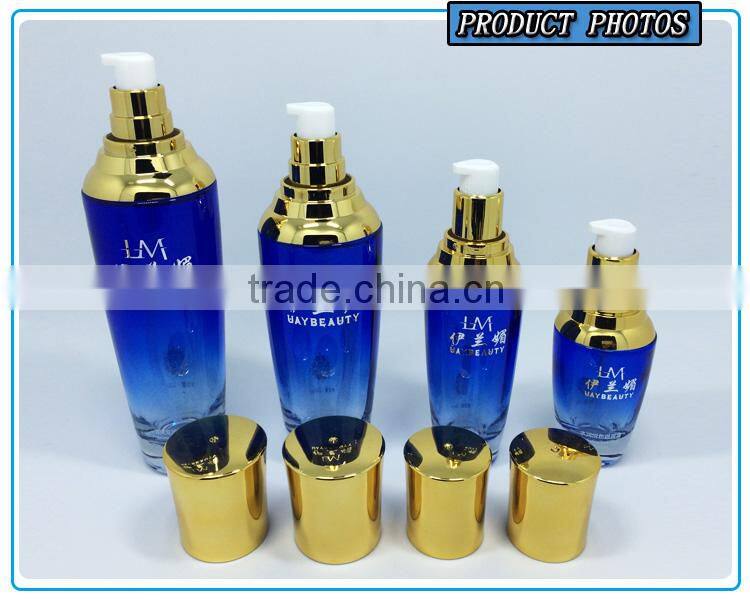 Bule colored glass cosmetic serum bottle and glass cosmetic cream jar with gold pump lid