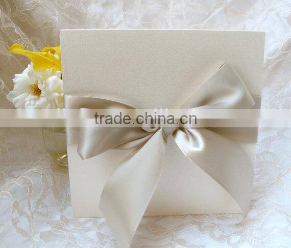 Ivory wedding invitation with bow