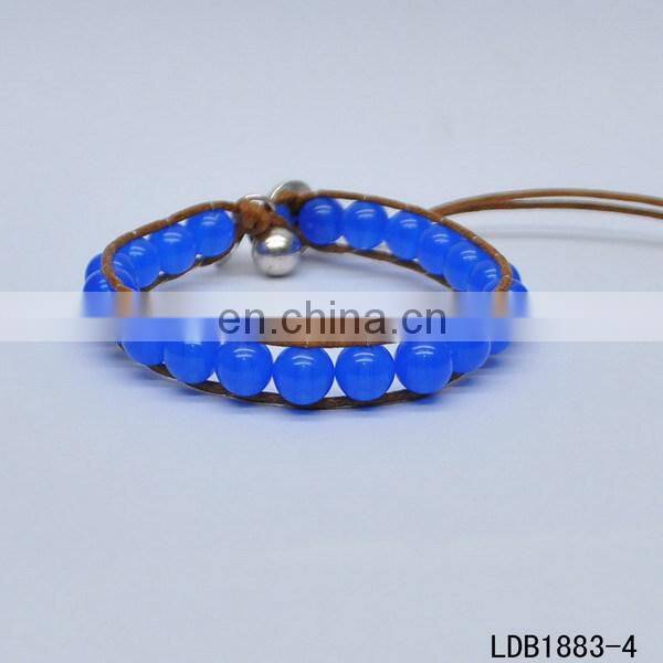 Handmade beaded wrap bracelet features 3 rows of circular and square stones surrounded by a natural colored cord on both sides