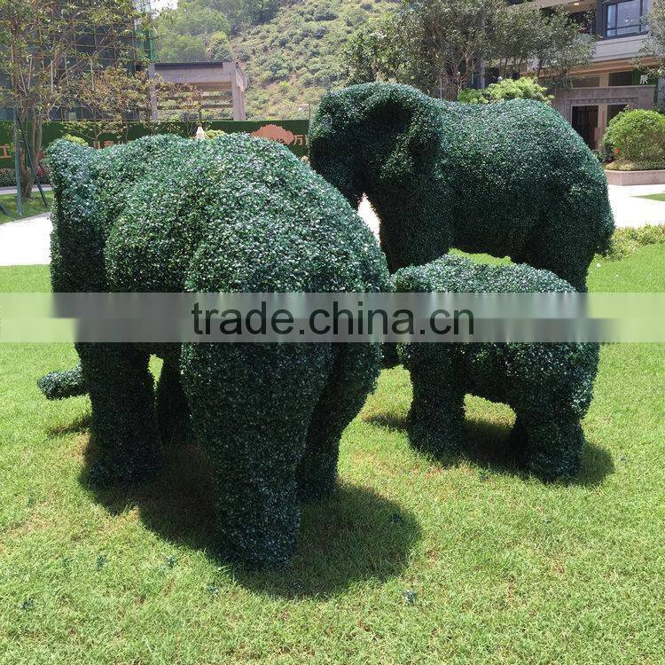 Green grass elephant statue