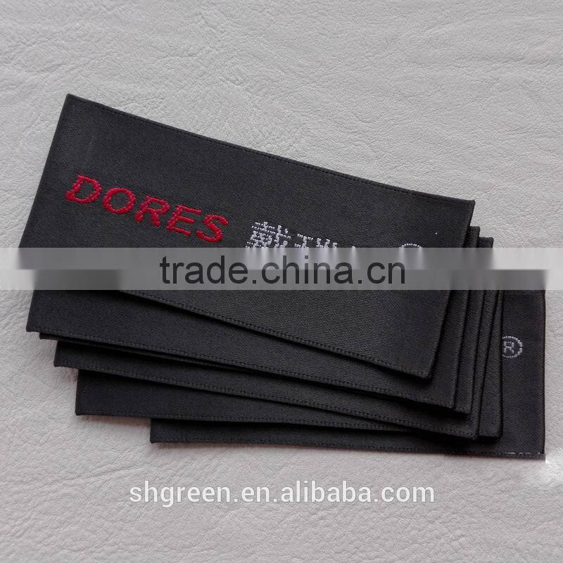 straight cut black background black logo woven label