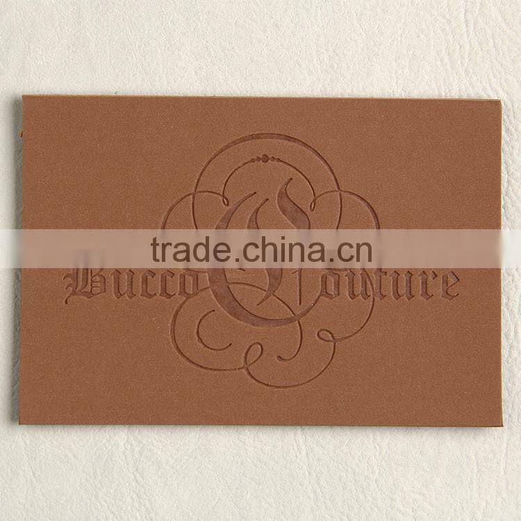 Imitation leather tag with embossed logo for young man pipestem pants