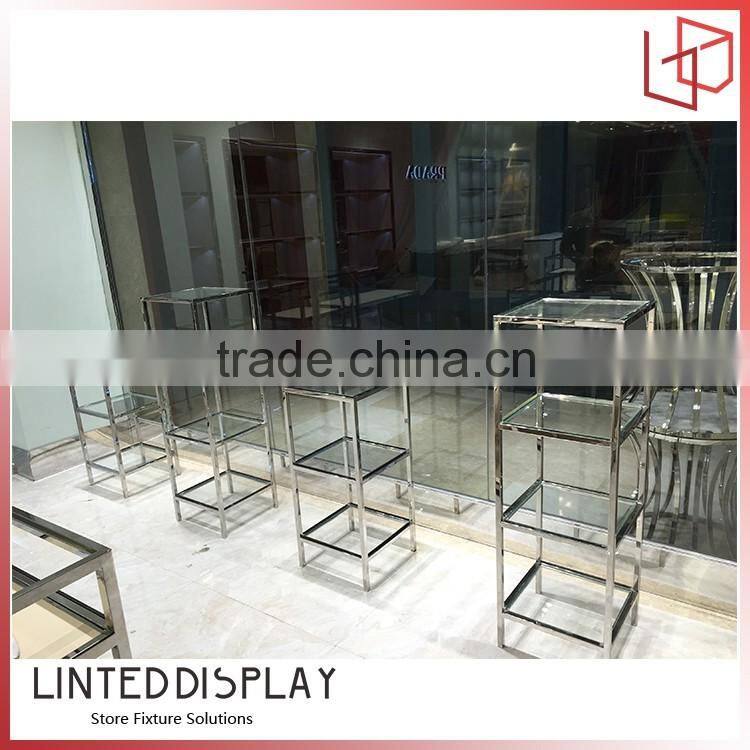 Unusual display stand for wall mounted retail clothing racks