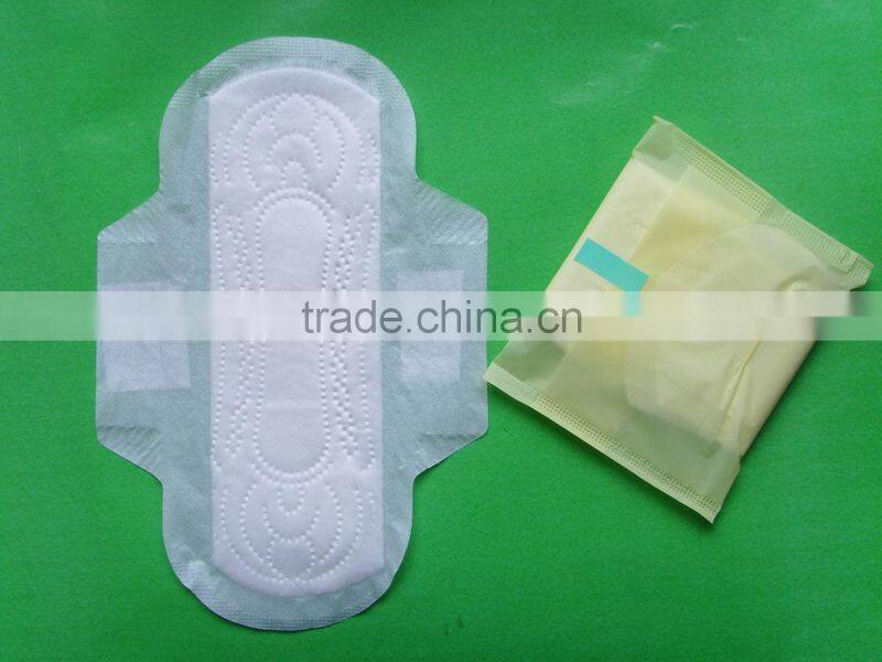 Disposable high absorbency dry surface sanitary napkin