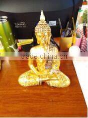 Monk meditatinng shinny Golden Statue
