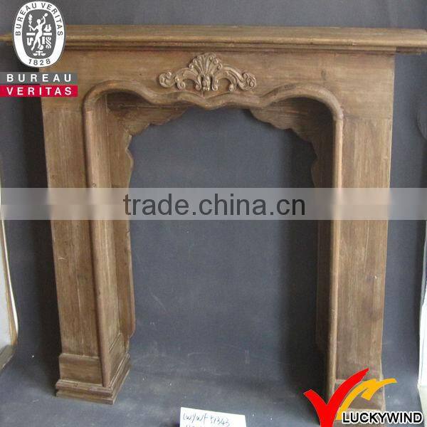 White antique wooden fireplace mantel