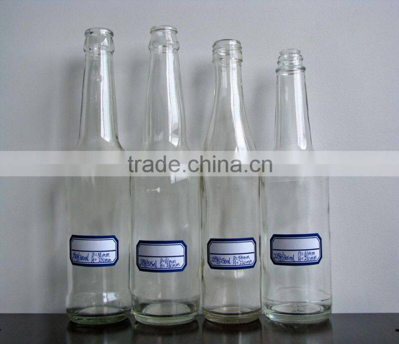 clear glass carbonated beverage bottle