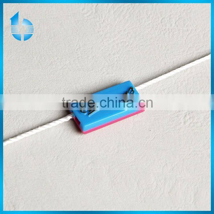 Durable plastic string seal for garment hangtag