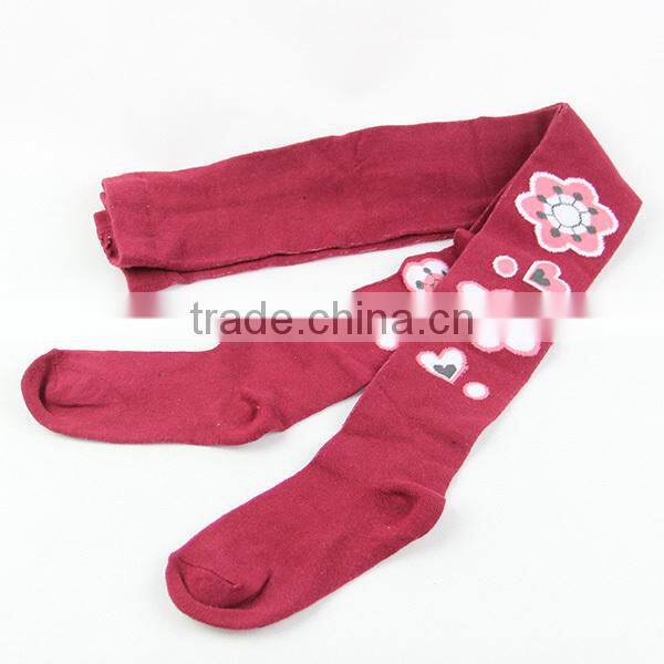 Red colored girls tight leggings with fashion flowers