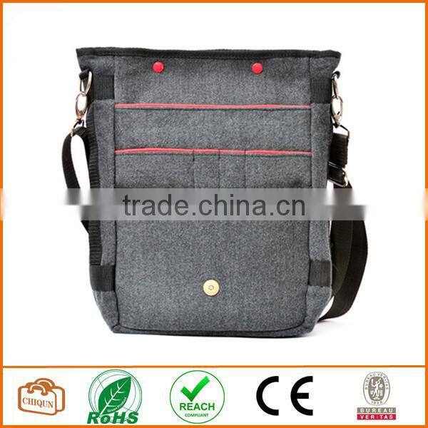 Unisex messenger bag and backpack. Grey Wool-Polyester mix with red details and lining. Multiple pockets