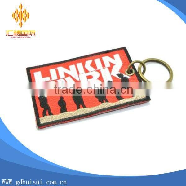 Popular design cheap customized elliptical shape embroidery personalized logo key chain
