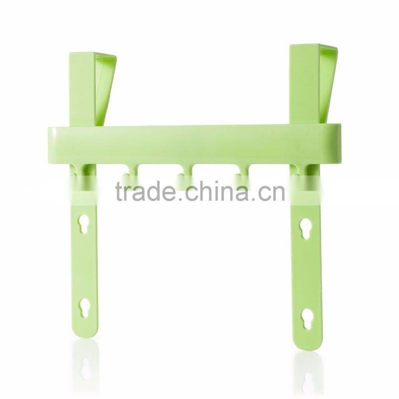 Multipurposed pothook behind the kitchen door