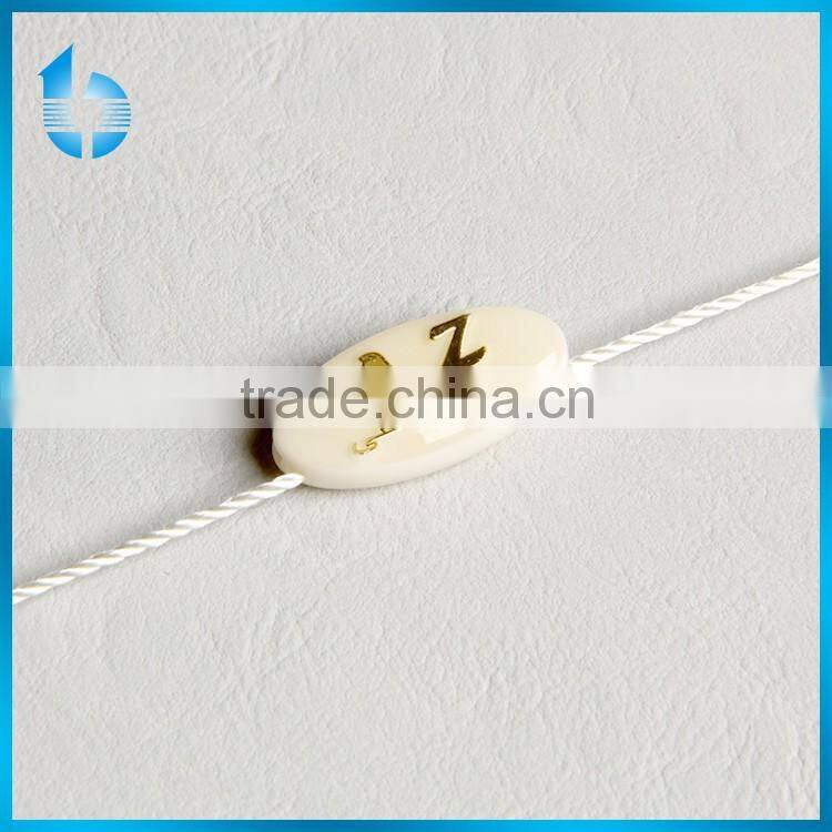 Plastic seal tag with string lock for deluxe garments
