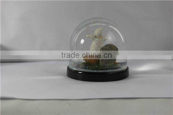 Plastic pumpkin halloween snow globe