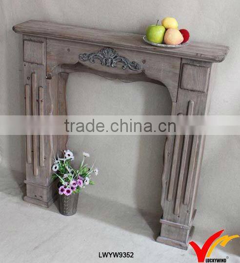 White antique wooden fireplace mantel